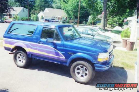 Blue SUV with purple and yellow side stripes, 3q-front view