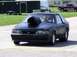 1990 Ford Mustang - A modified Ford Mustang with a prominent hood scoop is ready for a drag race.