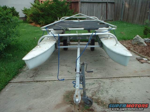White catamaran hull on a trailer, viewed from the front