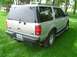 2001 Ford Expedition - This silver 2001 Ford Expedition is seen from the rear, parked on a grassy lawn.