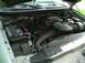 2001 Ford Expedition - The engine bay of a 2001 Ford Expedition is visible, with the hood open, revealing the V8 engine components and battery.