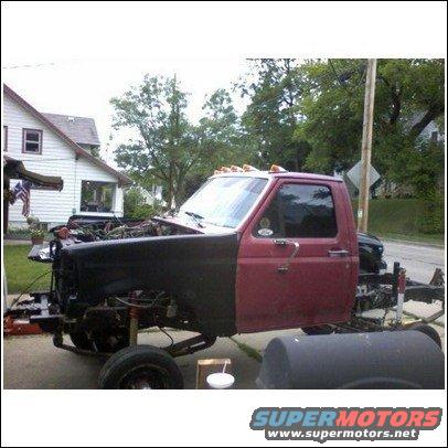 Red truck cab, black fender, exposed engine, 1994 Ford F-250