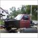 1994 Ford F-250 - This 1994 Ford F-250 is undergoing repairs, with its front end disassembled and engine exposed.