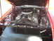 1972 Ford Ranchero - The engine compartment of a vehicle is open, revealing the V8 engine and its associated parts.