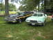 1972 Ford Ranchero - Two Ford Rancheros are parked on a grassy lawn under trees, with other vehicles in the background.