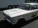 1972 Ford Ranchero - A white 1962 Ford Fairlane with racing decals and a hood scoop is parked outdoors.