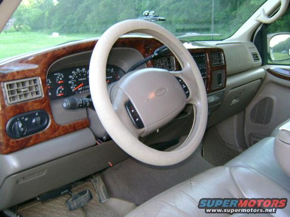 Interior shot of a 2000 Ford Excursion showing the dashboard, steering wheel, and seats