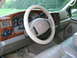 2000 Ford Excursion - The interior of a Ford Excursion features wood grain trim and a tan dashboard.