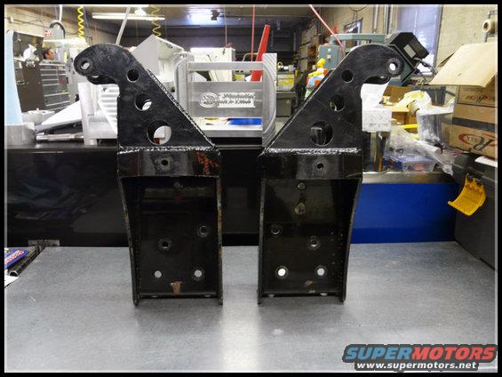 Pair of black metal brackets with circular cutouts
