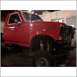 1994 Ford F-250 - This red pickup truck appears to be a 1992-1997 Ford F-Series, undergoing repairs in a garage.