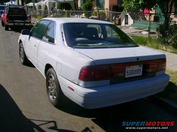 White 1989 Mazda MX-6 coupe, rear view, with louvers on rear window