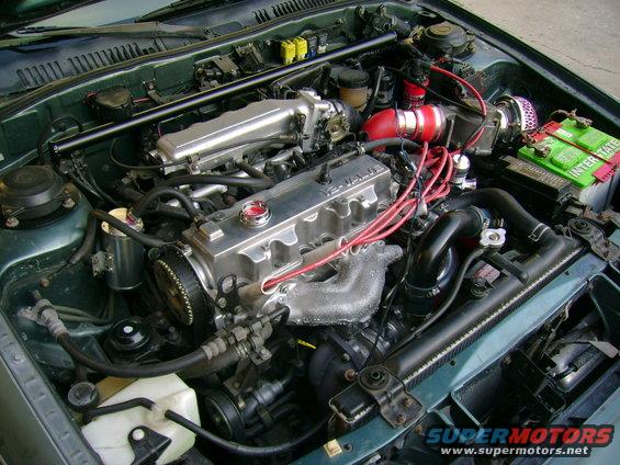 Engine bay with modified intake and polished valve cover