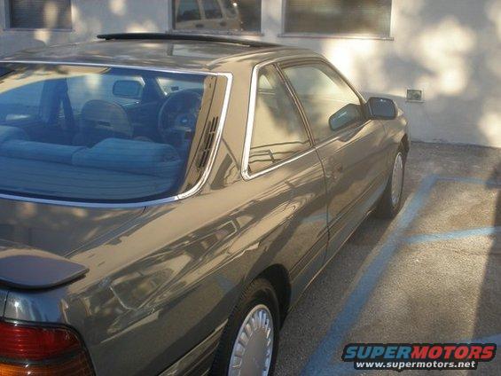 1989 Mazda MX-6 coupe parked in a lot, rear quarter view
