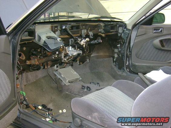 1989 Mazda MX-6 interior with dashboard removed, showing exposed wiring and components