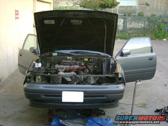 Gray coupe engine bay with hood and doors open