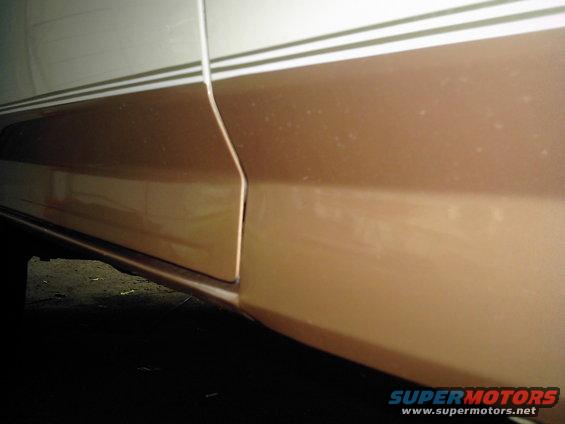 Two-tone brown and white vehicle side panel with pinstriping