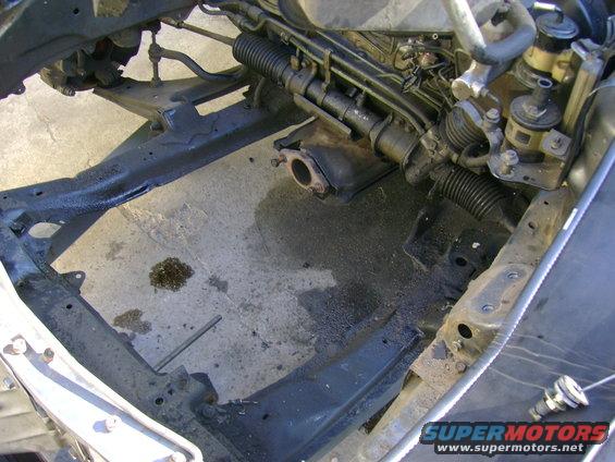 1989 Mazda MX-6 engine bay frame with visible steering rack and exhaust manifold