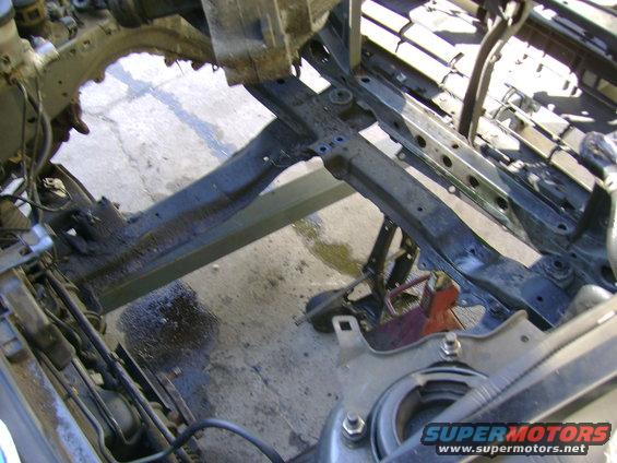 Car frame and suspension components, possibly from a disassembled vehicle