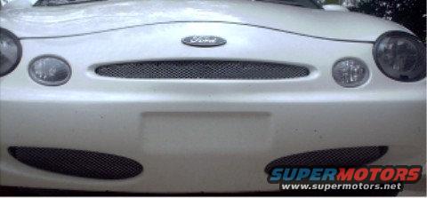 White 1997 Ford Taurus front end with oval headlights and mesh grille