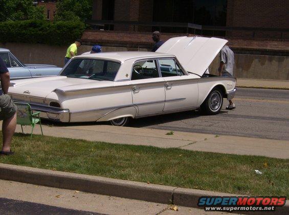 White 1960 sedan, side view, hood open
