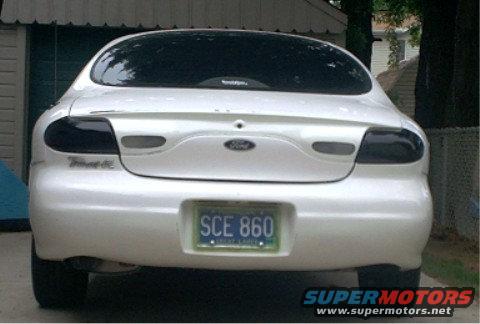 White 1997 Ford Taurus rear view with tinted taillights and license plate SCE 860