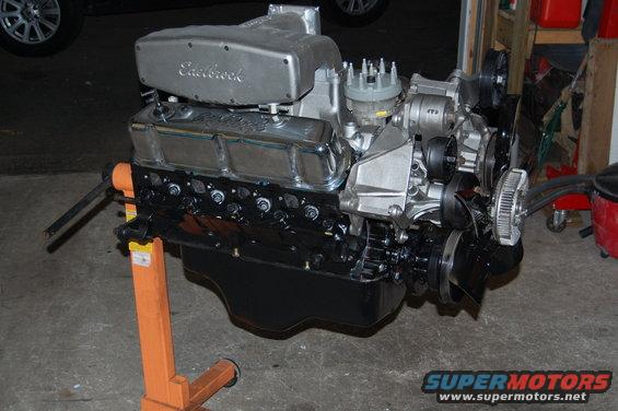 V8 engine with Edelbrock intake manifold on an orange engine stand