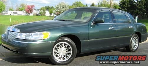 Green sedan, 3q front view. Watermark reads SUPERMOTORS.NET