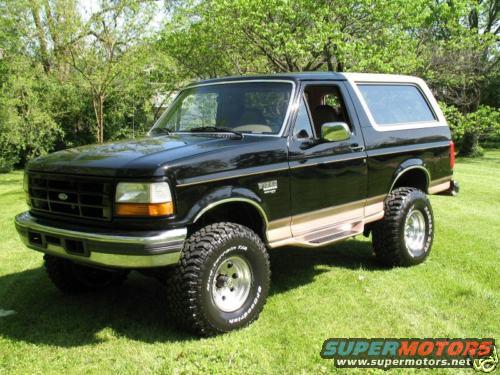 1996 Ford Bronco parked on grass with trees in background