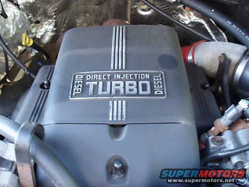 close-up of a diesel turbo engine cover with "DIRECT INJECTION TURBO DIESEL" text