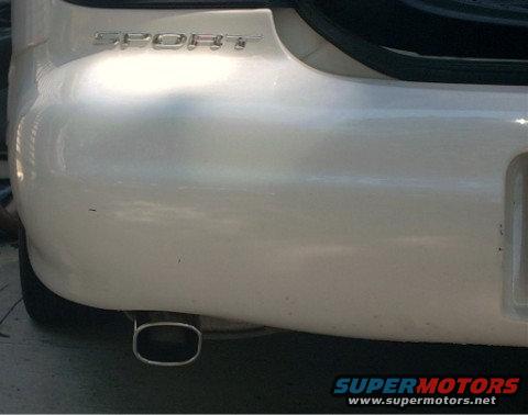 White car rear bumper with "SPORT" badge and oval exhaust tip