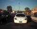 1997 Ford Taurus - Rear view of a white 1997 Ford Taurus parked in a lot with other vehicles.