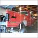 1994 Ford F-250 - This red pickup truck is in a garage, possibly undergoing repairs or modifications.