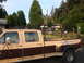 1988 Ford F-350 - Tan and brown Ford F-350 pickup truck with a ladder rack, seen from the side.
