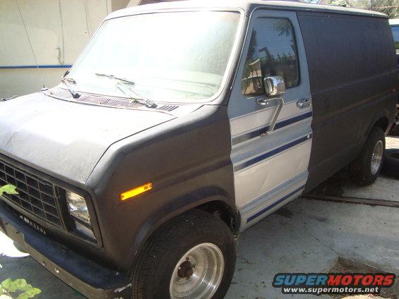 Ford Econoline van with two-tone paint and blue stripes, front quarter view