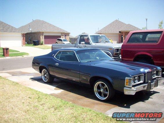Dark blue 1974 Mercury Cougar coupe parked in a driveway, front quarter view