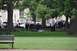 1996 Ford Bronco - Police officers are gathered in a park around a person lying on the grass near benches.
