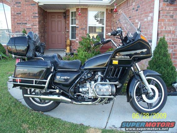 Black 1982 Honda GL1100I GW Interstate motorcycle parked in front of a brick house