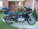 1982 Honda GL1100I GW Interstate - This Honda Gold Wing motorcycle is parked on a concrete driveway in front of a residential home.