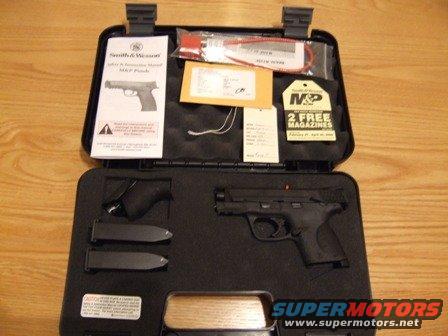 Black Smith & Wesson M&P pistol with two magazines and manual in a black case