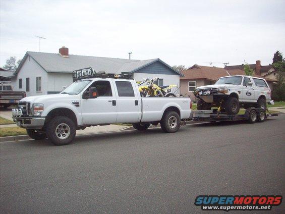 White 1992 Ford Bronco on trailer, 3q-front view