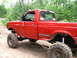 1994 Ford F-250 - This red 1994 Ford F-250 pickup truck is equipped for off-road use with a lifted suspension and large tires.