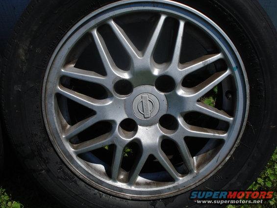 Close-up of a Nissan wheel with a multi-spoke design and the Nissan logo in the center