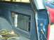 1990 Ford Bronco - Aftermarket car stereo components are visible inside a blue vehicle.
