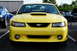 2002 Ford Mustang - Front view of a yellow 2002 Ford Mustang parked at a car show.