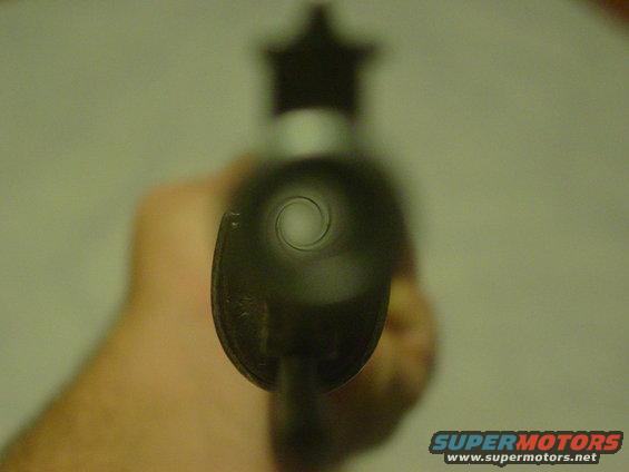 Gun barrel with rifling visible, held by a hand