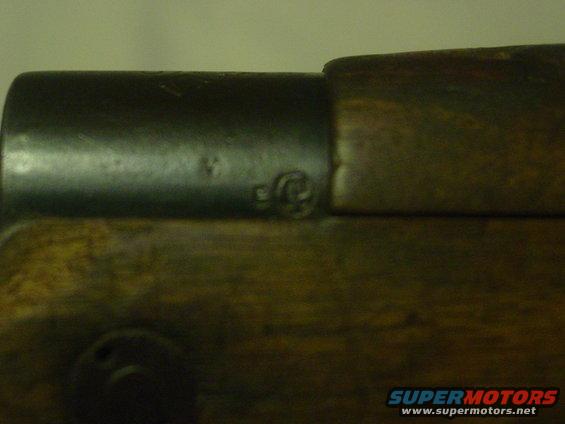 Close-up of firearm receiver with wood stock