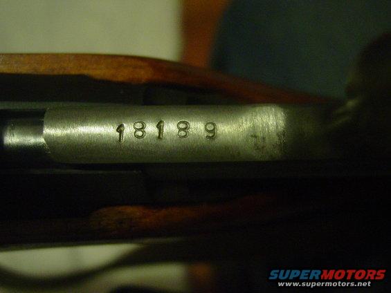 Close-up of serial number 18189 stamped on metal part of firearm