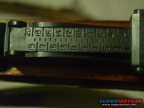 Close-up of gun sight markings with numbers 1-20