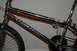 1998 BMW R1100GS ABS - Close-up of a chrome BMX bicycle frame, showing 'REAGENT' and 'VANS' branding.
