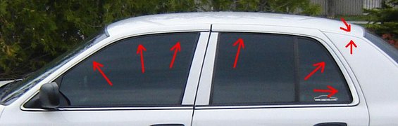 White 2003 Ford Crown Victoria side view with red arrows pointing to trim removal areas